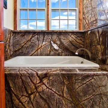 Rainforest Brown Granite vanity, tub surround, and shower wall