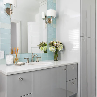 Example of a mid-sized transitional glass tile and blue tile multicolored floor bathroom design in St Louis with flat-panel cabinets, gray cabinets, an undermount sink and white countertops