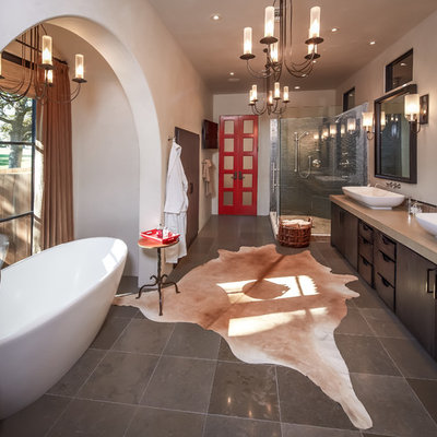 Bathroom - mid-sized eclectic master gray tile and mosaic tile gray floor and ceramic tile bathroom idea in Houston with a trough sink, flat-panel cabinets, dark wood cabinets, white walls, quartz countertops and a hinged shower door