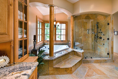 Alcove shower - huge rustic slate floor alcove shower idea in San Diego with raised-panel cabinets, medium tone wood cabinets, granite countertops and beige walls