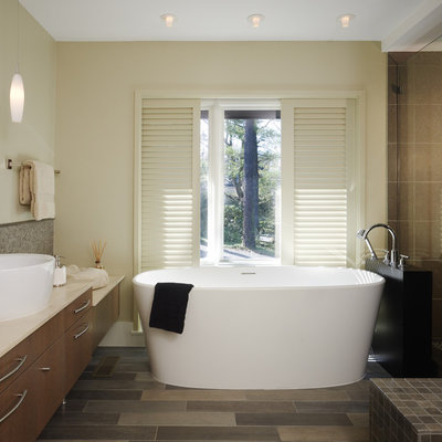 Freestanding bathtub - mid-sized contemporary master beige tile and porcelain tile porcelain tile freestanding bathtub idea in DC Metro with a vessel sink, flat-panel cabinets, beige walls and dark wood cabinets