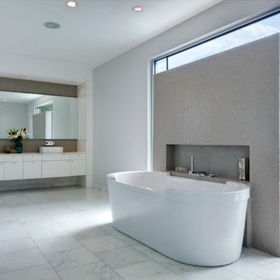 Trendy mosaic tile freestanding bathtub photo in Dallas with a vessel sink