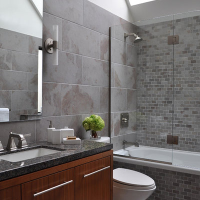 Trendy gray tile bathroom photo in Vancouver with an undermount sink, flat-panel cabinets and dark wood cabinets
