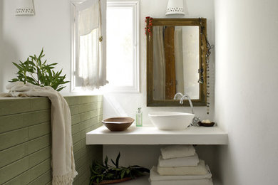 Example of a mid-sized transitional green tile and porcelain tile porcelain tile bathroom design in Atlanta with green walls, a vessel sink and solid surface countertops