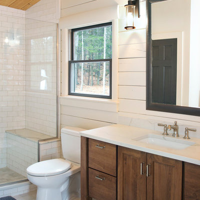 Large cottage master white tile and subway tile porcelain tile and gray floor alcove shower photo in New York with shaker cabinets, dark wood cabinets, a two-piece toilet, white walls, an undermount sink, quartz countertops, a hinged shower door and white countertops