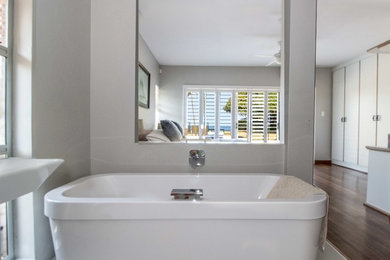 Inspiration for a mid-sized contemporary master corner bathtub remodel in Other with white countertops