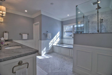 Example of a large classic master porcelain tile porcelain tile and white floor corner shower design in San Francisco with recessed-panel cabinets, white cabinets, an undermount tub, gray walls, an undermount sink, marble countertops and a hinged shower door