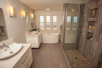 Photo of a large contemporary ensuite bathroom in Hawaii with shaker cabinets, white cabinets, a freestanding bath, a corner shower, grey walls, porcelain flooring, a built-in sink, brown floors and a hinged door.