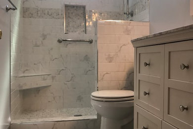 Example of a mid-sized transitional 3/4 gray tile, white tile and ceramic tile porcelain tile and gray floor bathroom design in San Diego with furniture-like cabinets, white cabinets, a two-piece toilet, gray walls, an undermount sink and granite countertops