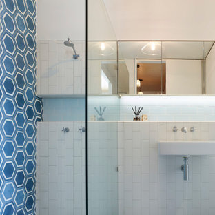 Design ideas for a small contemporary master bathroom in Brisbane with glass-front cabinets, blue tile, ceramic tile, white walls, cement tiles, blue floor, an alcove shower, an open shower, white benchtops and a wall-mount sink.