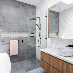 Design ideas for a mid-sized contemporary master bathroom in Sydney with flat-panel cabinets, medium wood cabinets, a freestanding tub, an open shower, a one-piece toilet, white tile, ceramic tile, white walls, ceramic floors, a drop-in sink, engineered quartz benchtops, grey floor, an open shower, white benchtops, a niche, a single vanity and a floating vanity.