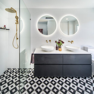 Photo of a contemporary master bathroom in Sydney with a one-piece toilet, white tile, ceramic tile, white walls, cement tiles, an open shower, white benchtops, flat-panel cabinets, black cabinets, a curbless shower, a vessel sink and multi-coloured floor.