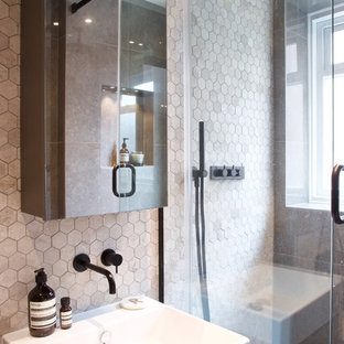 Small contemporary bathroom in Buckinghamshire with a corner shower, grey tiles, grey walls, a built-in sink and a hinged door.