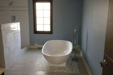 Bathroom - contemporary master bathroom idea in New York with a vessel sink, a one-piece toilet and blue walls