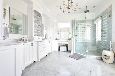 Trendy master gray tile and marble tile gray floor and marble floor corner shower photo in Other with raised-panel cabinets, white cabinets, white walls, an undermount sink, a hinged shower door, gray countertops and marble countertops