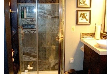 Example of a small classic 3/4 black tile and glass tile corner shower design in Seattle with beige walls, a vessel sink, flat-panel cabinets, dark wood cabinets and limestone countertops