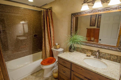 Example of a mid-sized classic 3/4 brown tile and stone slab travertine floor bathroom design in Salt Lake City with flat-panel cabinets, medium tone wood cabinets, a one-piece toilet, beige walls, an undermount sink and granite countertops