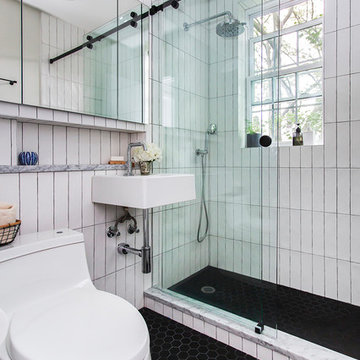 Renovated bathroom with glass-enclosed shower