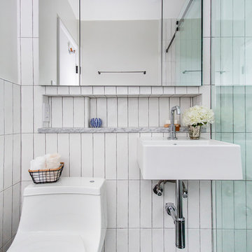 Renovated bathroom with vertically-stacked subway tile