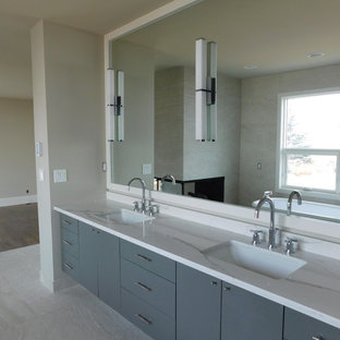 Photo of a mid-sized modern master bathroom in Calgary with flat-panel cabinets, grey cabinets, multi-coloured tile, mirror tile, grey walls, ceramic floors, a drop-in sink, granite benchtops and grey floor.