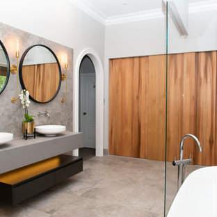 Inspiration for a large contemporary master wet room bathroom in Melbourne with open cabinets, black cabinets, a freestanding tub, a bidet, gray tile, ceramic tile, grey walls, ceramic floors, a console sink, engineered quartz benchtops, grey floor, an open shower, grey benchtops, a double vanity and a floating vanity.