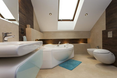 Small contemporary ensuite bathroom in Los Angeles with freestanding cabinets, white cabinets, a freestanding bath, a one-piece toilet, brown tiles, multi-coloured walls, porcelain flooring, an integrated sink, engineered stone worktops, beige floors and white worktops.