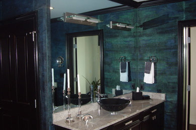 Inspiration for a contemporary bathroom remodel in Miami with recessed-panel cabinets, dark wood cabinets, green walls, a vessel sink and granite countertops