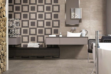 Example of a large minimalist master gray tile and ceramic tile ceramic tile freestanding bathtub design in Perth with a vessel sink, flat-panel cabinets, gray cabinets and gray walls