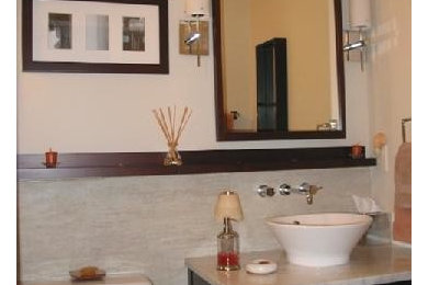 Example of a trendy porcelain tile and beige tile bathroom design in DC Metro with a vessel sink, flat-panel cabinets, dark wood cabinets and marble countertops