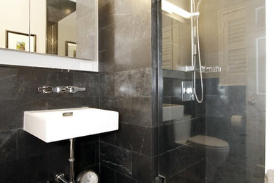 Inspiration for a small modern bathroom in Other with black tiles, stone tiles and marble flooring.