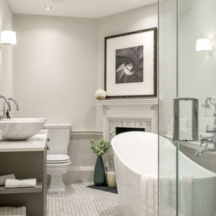 Large classic ensuite bathroom in London with shaker cabinets, grey walls, quartz worktops, grey floors, a hinged door, grey cabinets, a freestanding bath, a corner shower, mosaic tile flooring, a vessel sink and white worktops.
