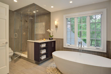 Inspiration for a large contemporary master gray tile and porcelain tile porcelain tile and beige floor bathroom remodel in New York with flat-panel cabinets, dark wood cabinets, marble countertops, a one-piece toilet, an undermount sink, gray walls and a hinged shower door