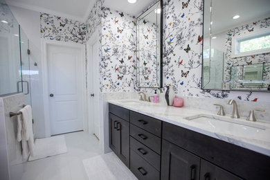 Trendy master white tile and ceramic tile porcelain tile and white floor wet room photo in Other with recessed-panel cabinets, brown cabinets, multicolored walls, an undermount sink, granite countertops and a hinged shower door