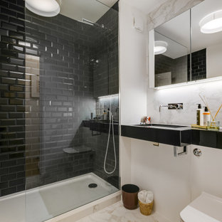 Design ideas for a medium sized contemporary shower room bathroom in London with open cabinets, black cabinets, an alcove shower, a wall mounted toilet, black tiles, metro tiles, white walls, an integrated sink, beige floors and black worktops.