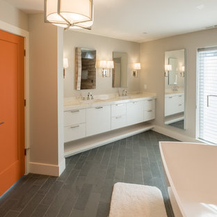 Inspiration for a large modern master brown tile and porcelain tile slate floor and gray floor bathroom remodel in Detroit with flat-panel cabinets, white cabinets, gray walls, an undermount sink, quartzite countertops and a hinged shower door