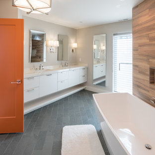 Bathroom - large modern master brown tile and porcelain tile slate floor and gray floor bathroom idea in Detroit with flat-panel cabinets, white cabinets, gray walls, an undermount sink, quartzite countertops and a hinged shower door