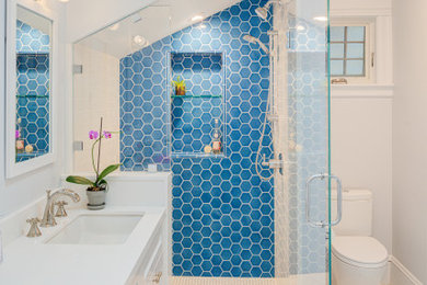 Example of a large transitional 3/4 stone tile and blue tile white floor alcove shower design in San Francisco with white walls, an undermount sink, quartzite countertops, white countertops, shaker cabinets, white cabinets, a two-piece toilet and a hinged shower door