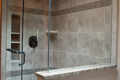 Example of a mid-sized transitional master beige tile and porcelain tile porcelain tile and beige floor corner shower design in Denver with beige walls and a hinged shower door