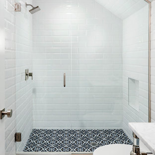 Minimalist white tile and subway tile cement tile floor alcove shower photo in Orlando with white walls, a pedestal sink and a hinged shower door