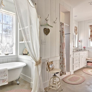 Inspiration for a shabby-chic style concrete floor bathroom remodel in Austin with a vessel sink, white cabinets and white walls