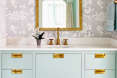 This is an example of a small classic bathroom in Other with flat-panel cabinets, blue cabinets, grey walls, a submerged sink and white floors.