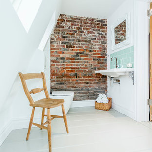 Photo of a beach style bathroom in Hampshire with painted wood floors.