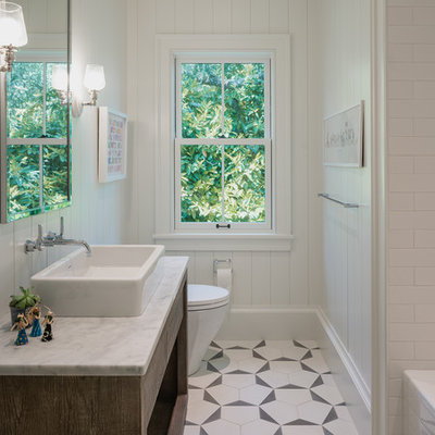 Example of a mid-sized trendy 3/4 white tile and subway tile white floor and mosaic tile floor bathroom design in San Francisco with flat-panel cabinets, white walls, a vessel sink, white countertops, dark wood cabinets, a one-piece toilet and marble countertops