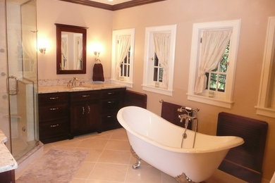 Example of a classic master beige tile and ceramic tile ceramic tile bathroom design in Detroit with a drop-in sink, recessed-panel cabinets, dark wood cabinets, granite countertops and beige walls