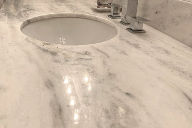 Inspiration for a contemporary porcelain tile and gray floor bathroom remodel in Los Angeles with shaker cabinets, light wood cabinets, white walls, an undermount sink, quartzite countertops and white countertops