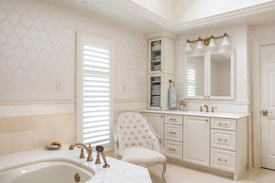Inspiration for a large timeless master white tile and stone tile marble floor alcove shower remodel in New Orleans with raised-panel cabinets, white cabinets, an undermount tub, a one-piece toilet, white walls, an undermount sink and marble countertops