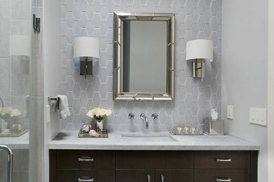 Inspiration for a small transitional master gray tile and ceramic tile porcelain tile corner shower remodel in San Francisco with an undermount sink, flat-panel cabinets, dark wood cabinets, marble countertops, an undermount tub, a wall-mount toilet and gray walls