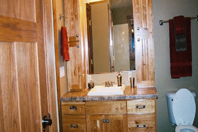 Bathroom photo in Other with flat-panel cabinets and light wood cabinets