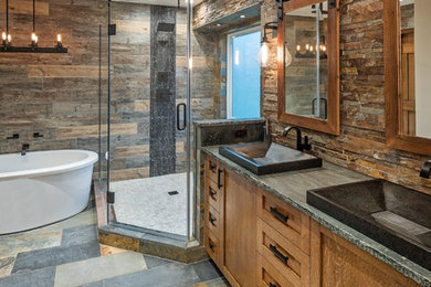 Mountain style master brown tile and stone tile bathroom photo in Omaha with shaker cabinets, medium tone wood cabinets and soapstone countertops