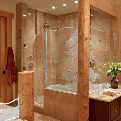 Example of a mountain style master ceramic tile and brown tile ceramic tile corner shower design in Seattle with dark wood cabinets, quartzite countertops, furniture-like cabinets and a hinged shower door